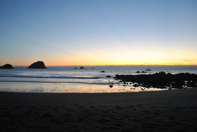 The sun sets over a black sand beach near Crescent City, Calif., in October of 2014. 